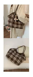 Detail of plaid tote bag with brown leather strap and cute bunny pendant charm