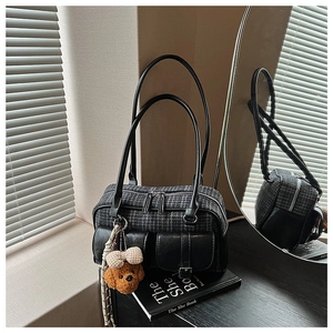 Détail du sac à carreaux avec poches à boucle et charmant pendentif ours en peluche