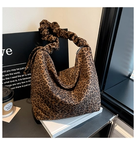 Detail of the leopard print tote bag with soft scrunchie handle and secure zipper closure