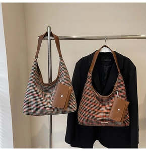 Detail of high-capacity houndstooth hobo bags with leather straps and mini pouches