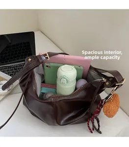 Macro view of spacious interior of brown leather tote bag showing large storage capacity