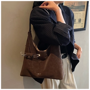 Macro detail of dark brown suede tote bag with stylish integrated eyewear holder