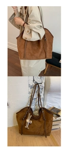 Detail view of large brown suede tote bag with plush bunny charm in a cozy lifestyle setting