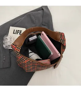 Interior view showing the large capacity of the vintage plaid tote bag with daily items