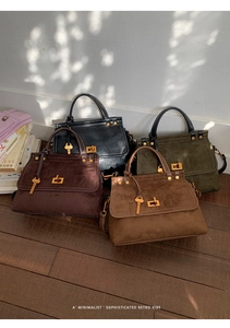 Minimalist retro handbags in black leather and frosted suede with gold hardware detail