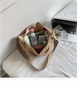 Spacious interior of beige nylon crossbody bag showing storage for daily essentials