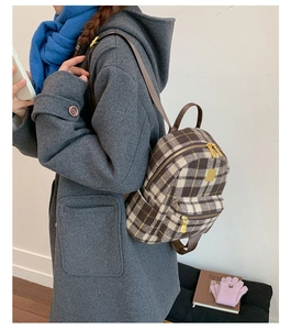 Classic coffee plaid backpack made of tweed fabric shown from a side-view angle