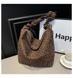 Detail of the leopard print tote bag featuring a unique gathered ruched shoulder strap