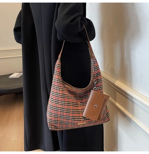 Detail of vintage plaid tote bag and small leather pouch with orange houndstooth pattern