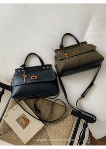 Detail view of retro trapezoid handbags with metal twist locks and key charms