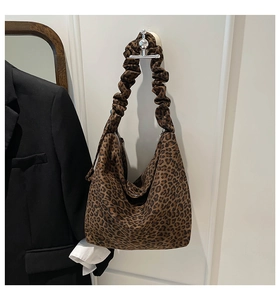 Leopard print tote bag detail showing large capacity and unique ruched shoulder strap