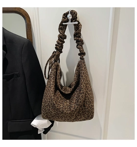 Detail of leopard print hobo bag featuring a unique ruched cloud-style shoulder strap