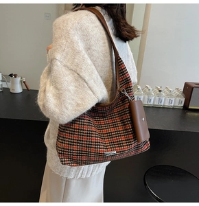 Detail of vintage houndstooth tote bag with leather trim and matching hanging pouch