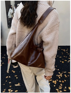 Detail of vintage brown tote bag with white contrast stitching and Ohloe's m u logo