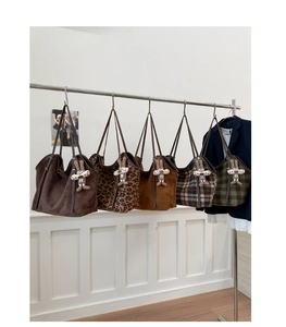 Detailed view of five large capacity tote bags with plaid patterns and rabbit charms