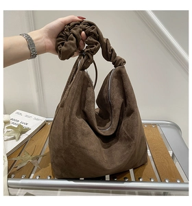 Close-up of leopard print tote bag with brown suede texture and ruched handle detail