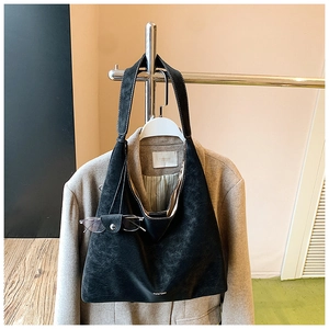 Detail of black matte leather tote bag with white stitching and leather eyewear case holder