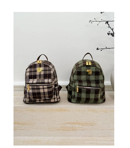 Detail of tweed checkered backpacks with premium gold zippers and hardware