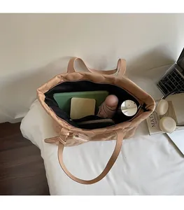 Top view showing the spacious interior of the beige quilted tote bag for daily essentials