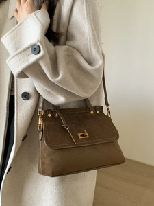 Retro brown suede tote bag with gold twist lock and shoulder strap on model