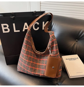Detailed close-up of houndstooth plaid fabric and mini pouch on retro hobo shoulder bag