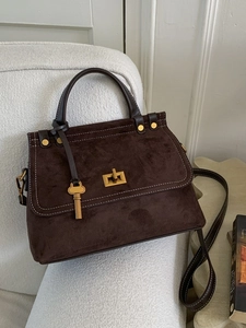 Vintage dark brown frosted leather handbag with gold twist lock and a key pendant