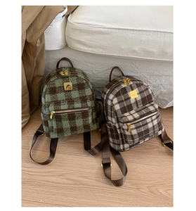 Detailed macro view of plaid tweed mini backpacks with premium golden metal zippers