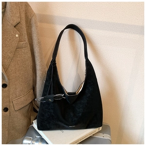 Detail shot of a black suede Hobo bag with Chio'2nd logo on minimal background