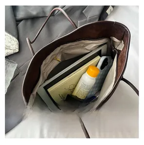 Interior view of brown suede tote bag showing large capacity and zipper pocket