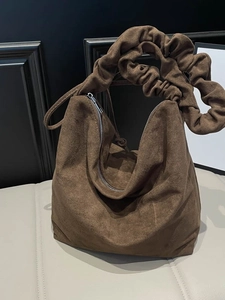 Brown faux suede crescent tote bag with pleated wide shoulder strap and silver zipper
