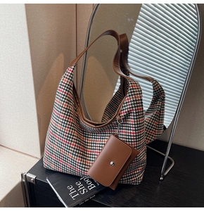 Detail of vintage houndstooth tote bag with brown leather trim and matching coin purse
