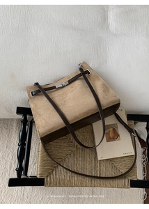 Detail shot of vintage khaki suede tote bag with brown straps and silver metal swivel lock