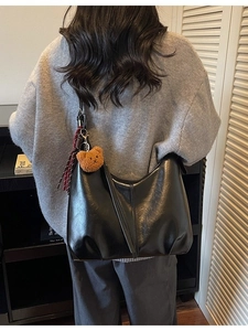 Retro large capacity black crescent shoulder bag with bear pendant and tassel decoration