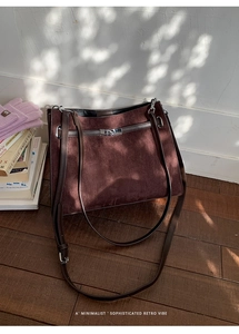 Close-up of vintage brown suede tote bag featuring leather strap and silver metal twist lock