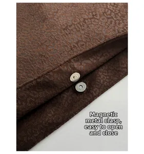 Detailed macro view of high-quality metal magnetic buckles on leopard print tote bag
