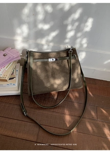 Detail of vintage olive green suede tote bag featuring classic silver twist lock closure
