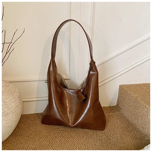 Close-up of retro large capacity hobo bag in dark brown with soft leather texture