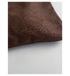 Detail view of reinforced bottom and leopard print suede fabric on large tote bag