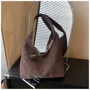 Detail view of large Maillard brown hobo bag with vintage texture and wide strap
