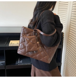 Detail of dark coffee quilted tote bag showing fine diamond stitching and plush leather texture