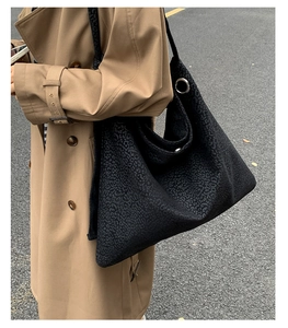 Detail of black leopard print tote bag with metal ring and thick canvas texture