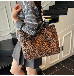 Detail of leopard print tote bag with black braided shoulder straps for women