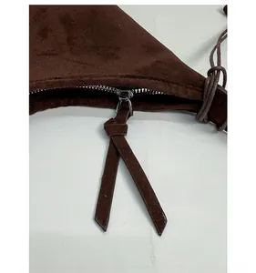 Detail of premium brown faux suede tote bag featuring a durable silver metal zipper closure