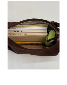Top view of large brown suede hobo bag interior showing ample storage for daily essentials