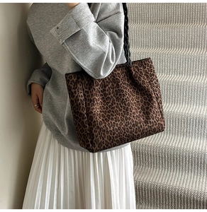 Close-up of vintage leopard print tote bag with thick black woven shoulder strap detail