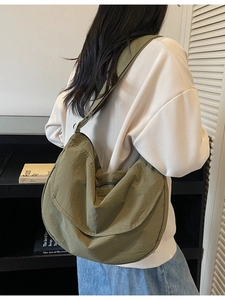 Olive green nylon crossbody crescent bag with adjustable wide strap and water-resistant fabric