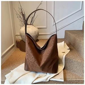 Detail of leopard print tote bag with reinforced leather corners and wide shoulder strap