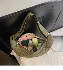 Detail view of olive green quilted bag showing spacious interior for tablets and essentials