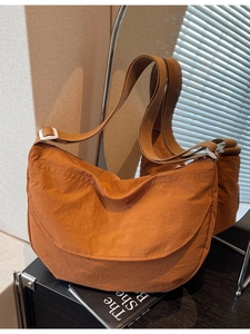 Spacious orange nylon crescent crossbody bag with adjustable wide strap for daily use