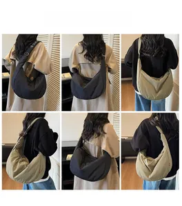 Detail view of large capacity half-moon crossbody bag in black and khaki colors